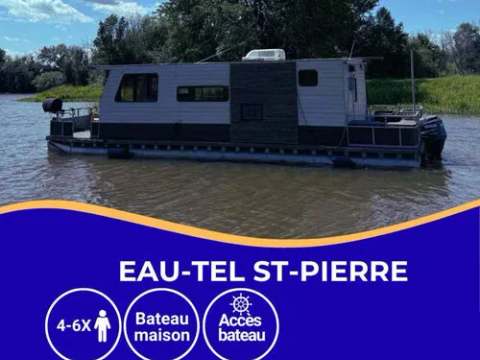 Side view of a houseboat on the water.