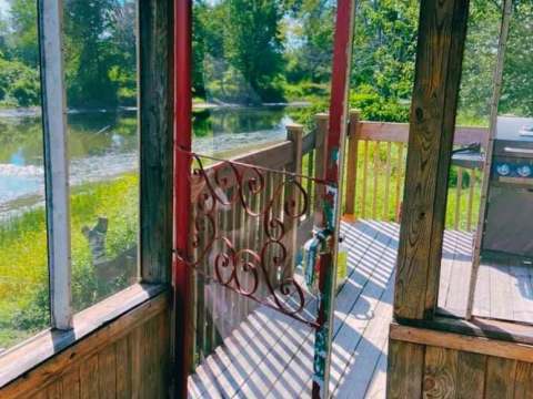 View from the Bihoreau cabin veranda overlooking the water and outdoor deck.