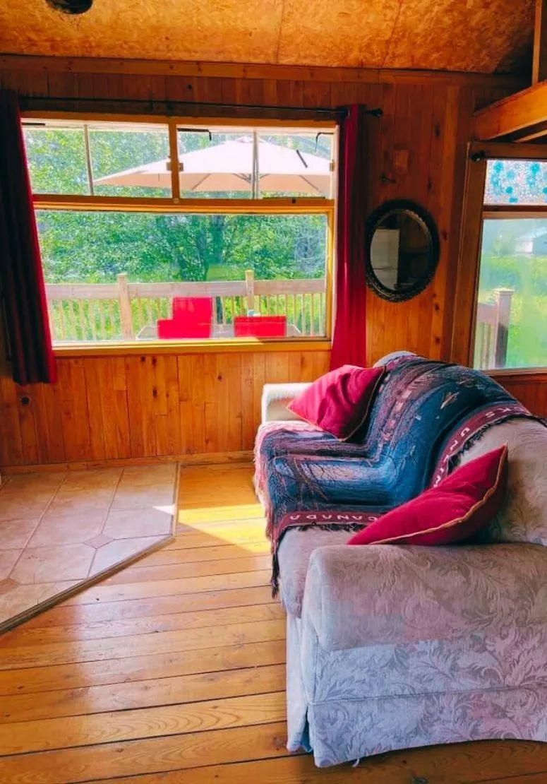 A cozy living room with a comfortable sofa overlooking the chalet's outdoor deck.