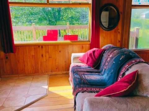 A cozy living room with a comfortable sofa overlooking the chalet's outdoor deck.