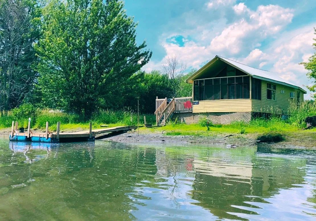 View of the L'Eau-Tel cabin with its private dock by the water.