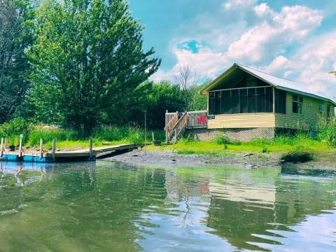 View of the L'Eau-Tel cabin with its private dock by the water.
