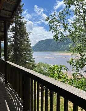 View of the water and mountains from the balcony of the Le Montagnais cabin.