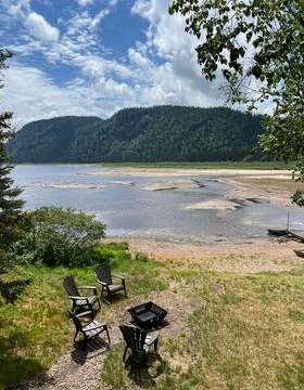 Enjoy the lake view and the fire pit area in front of Le Montagnais cottage.
