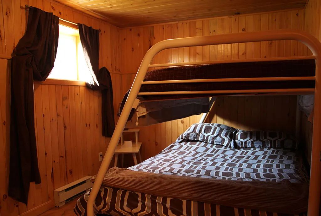 This bedroom features a bunk bed with comfortable bedding.