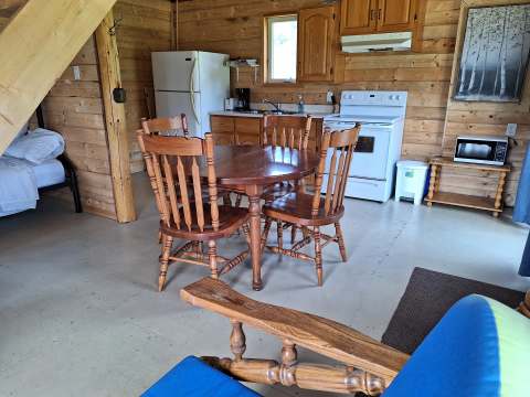 The equipped kitchen and open dining area of the Matalik cabin.