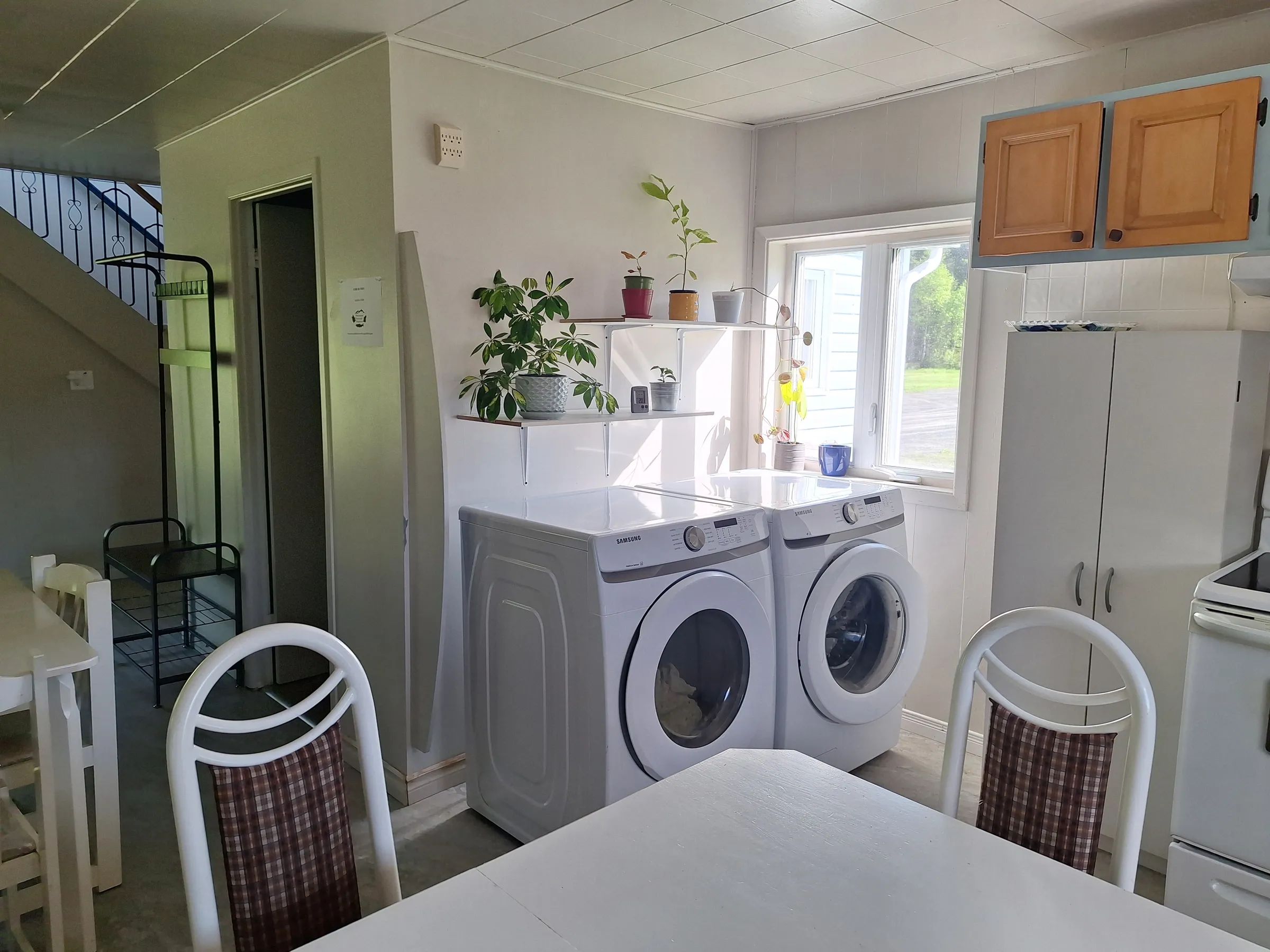 View of the kitchen equipped with a washer and dryer in the main cottage.