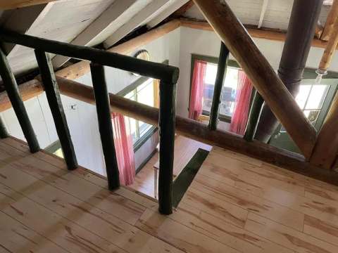 High-angle view from the chalet's mezzanine overlooking the main living area.