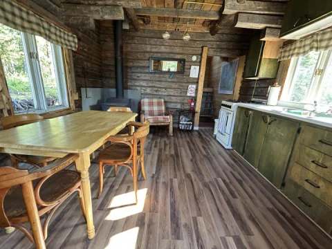 The chalet's kitchen and dining area are set in a rustic log cabin space.