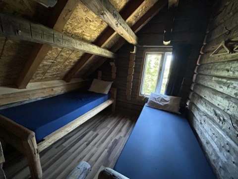 This bedroom under the roof of the Hibou cabin features two single beds.
