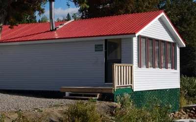 Vue extérieure du chalet Stéphane avec son toit rouge et son revêtement pâle.