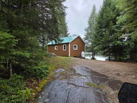 Chalet 12 is located at the edge of the forest near the lake.