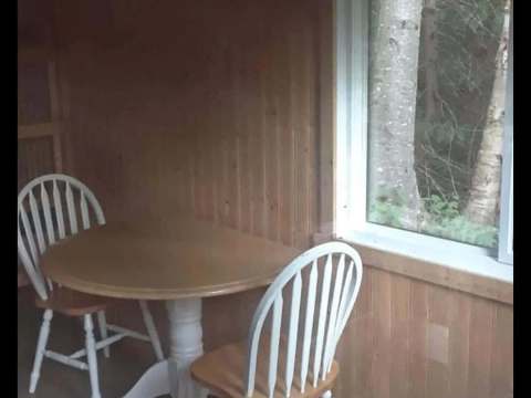 Dining area with round table and two chairs in cabin 10.