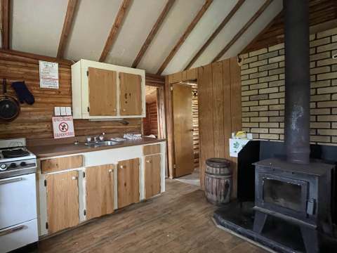 View of the kitchen area and wood stove in cabin 2.