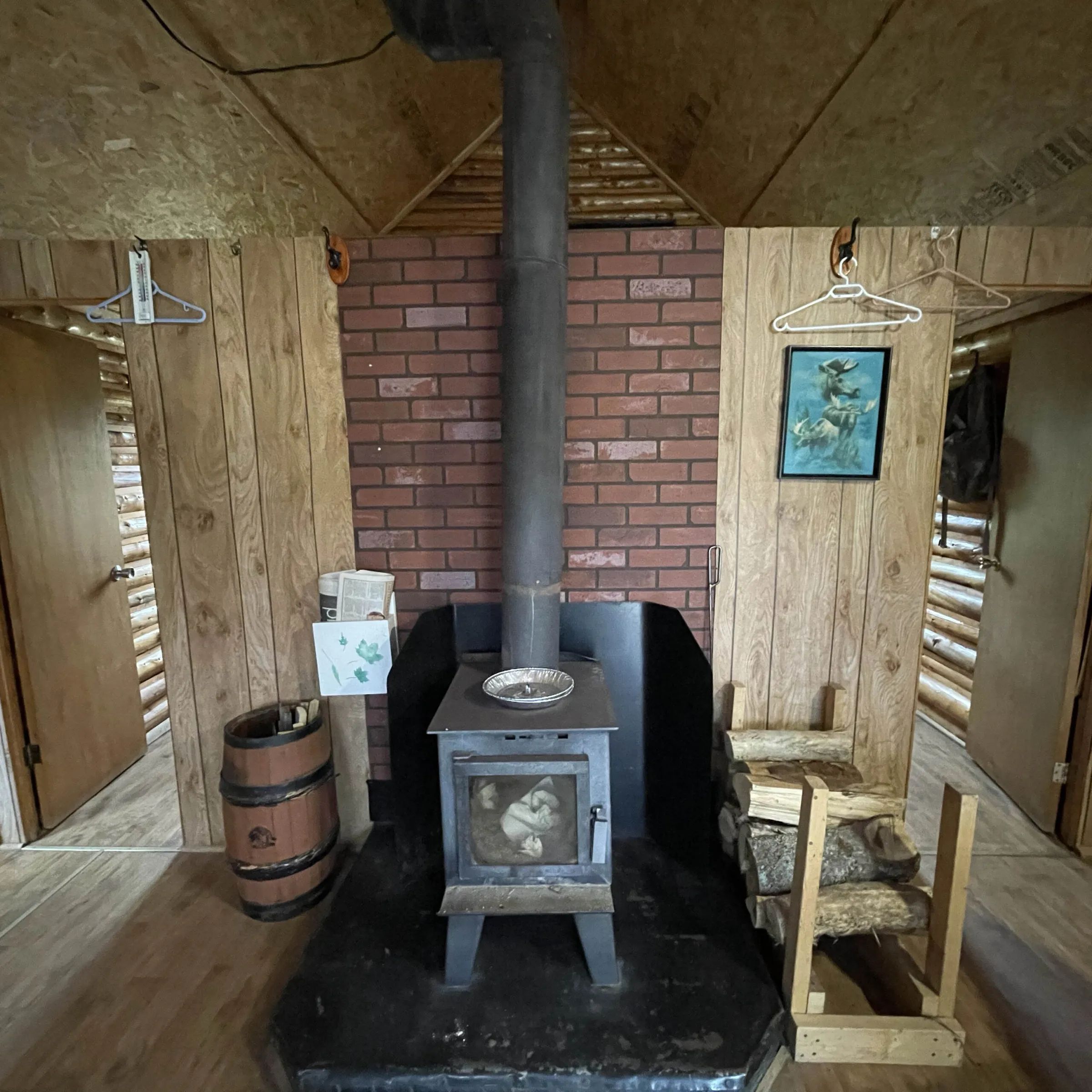 The cabin living area is equipped with a wood stove for your comfort.