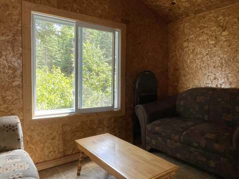 The cottage living room is furnished with a comfortable sofa and a coffee table.