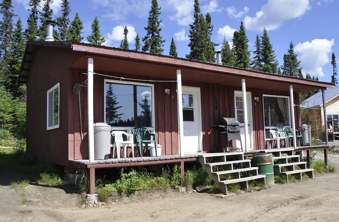 Exterior view of cabin 8 featuring its porch and outdoor furniture.