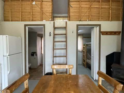 View of the cabin dining area with access to the bedrooms and the mezzanine.