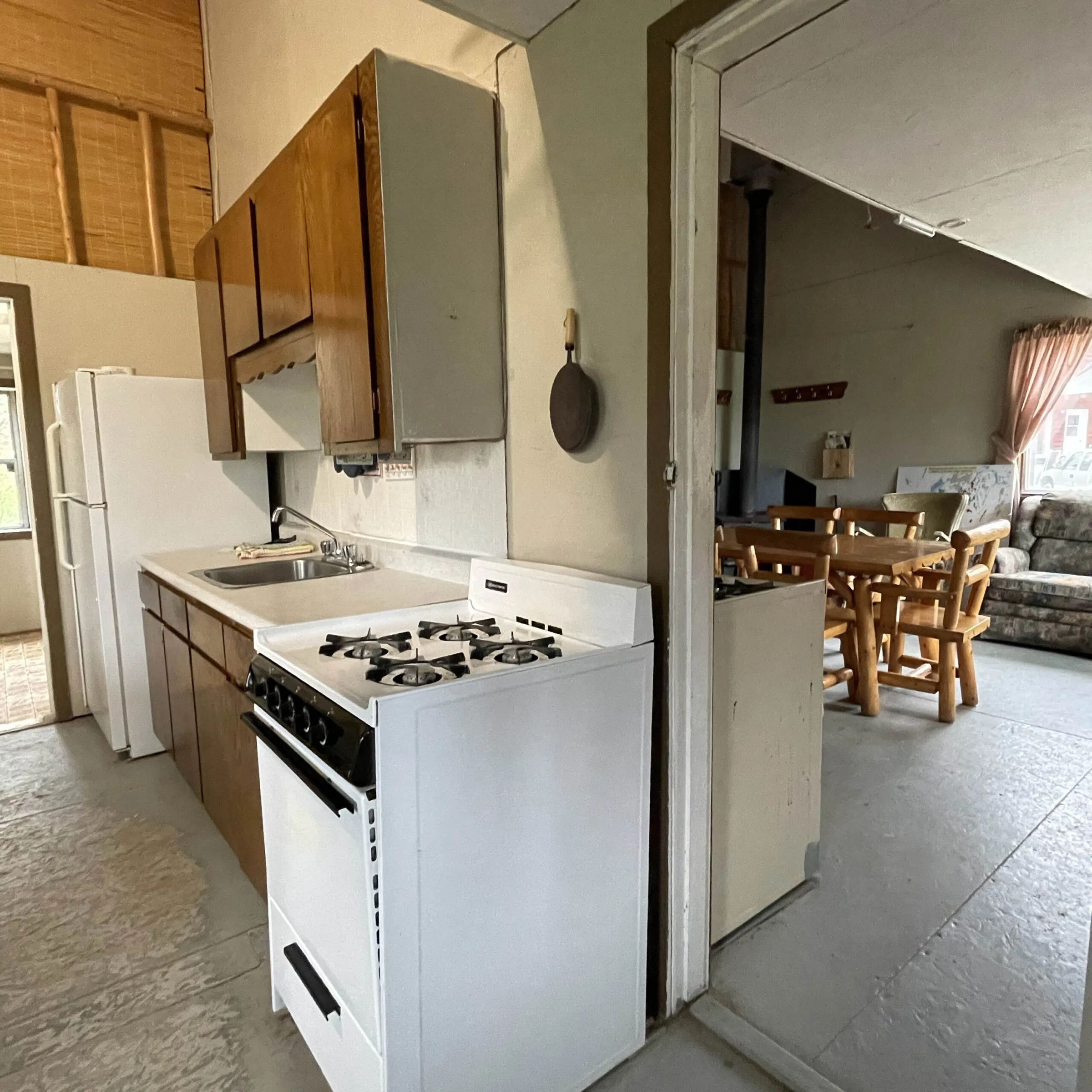 La cuisine fonctionnelle du chalet s'ouvre sur une salle à manger chaleureuse.