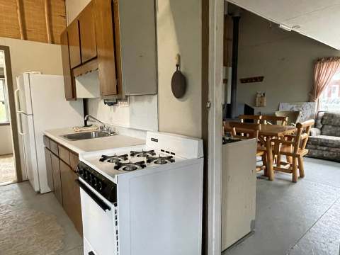 La cuisine fonctionnelle du chalet s'ouvre sur une salle à manger chaleureuse.
