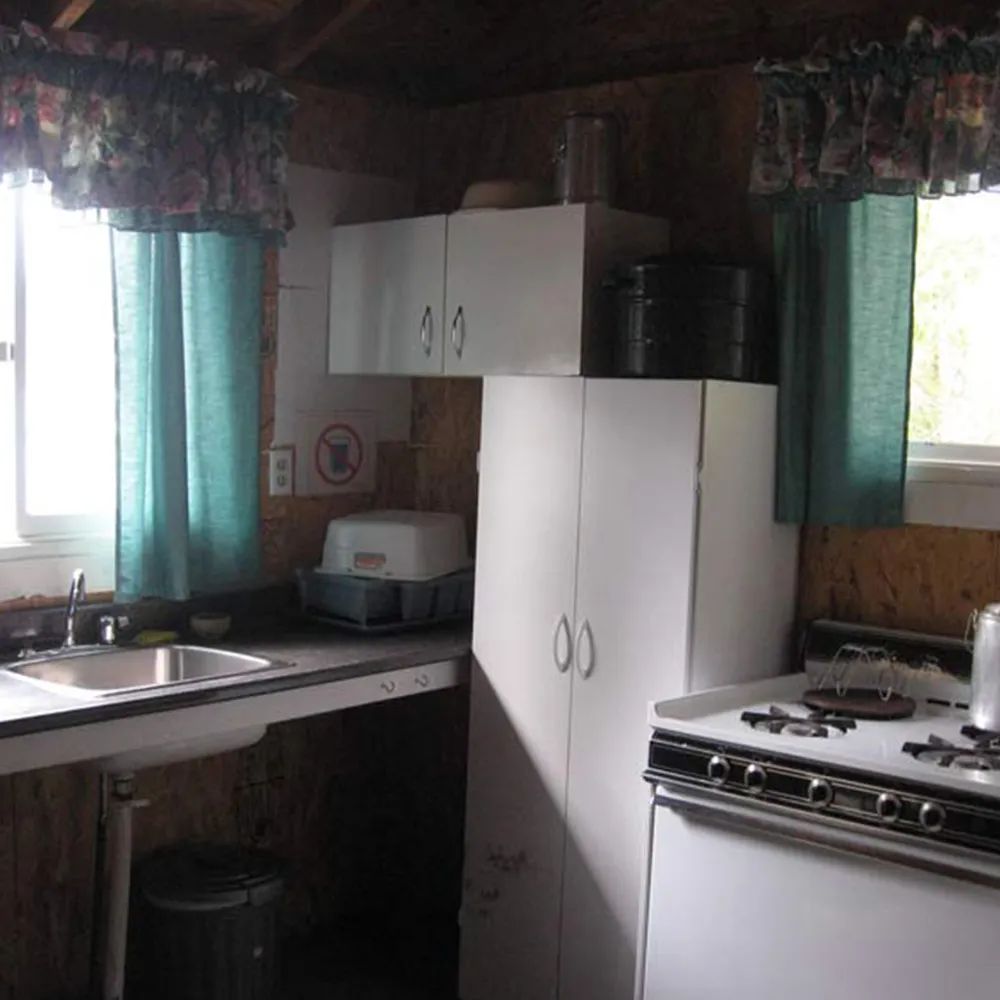The chalet's functional kitchen includes a sink, a stove, and storage space.