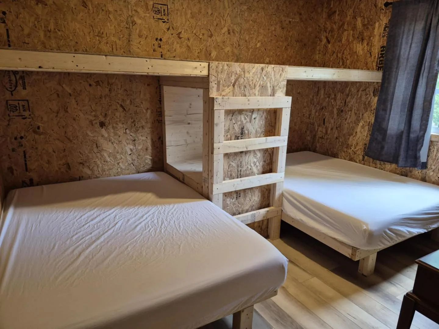 Chalet bedroom featuring wooden bunk beds with bedding included.