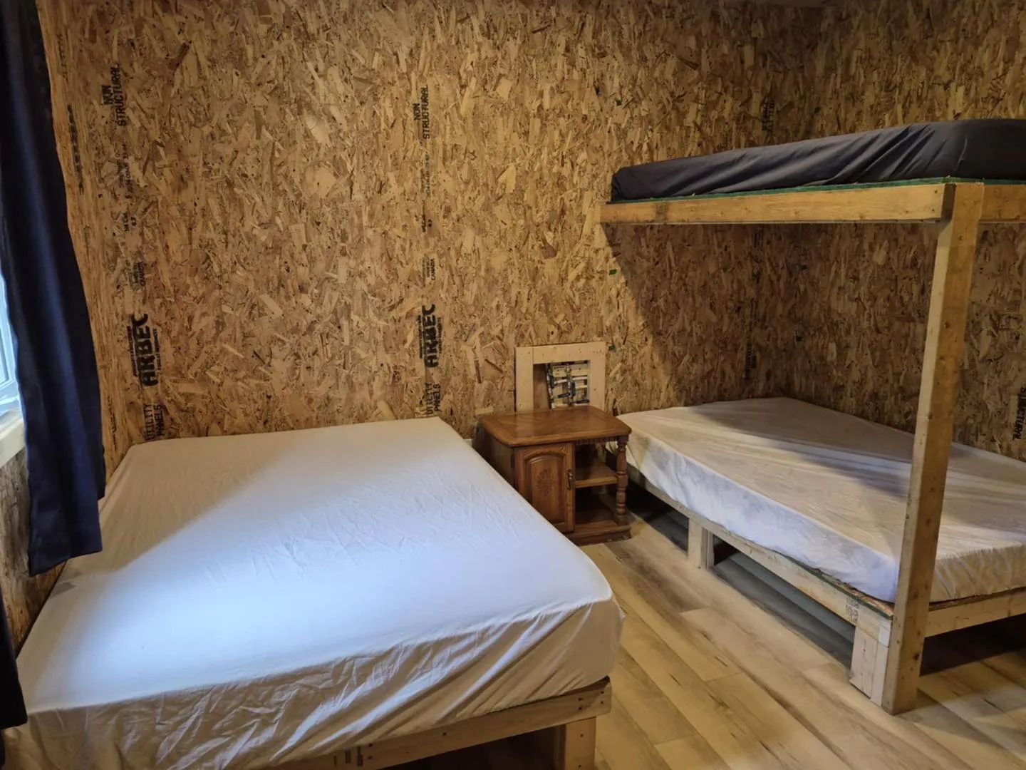 This bedroom in chalet 7 is equipped with a single bed and a bunk bed.
