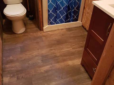 View of the functional bathroom with shower and toilet in the cabin.