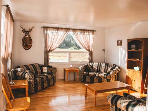 The house living room offers a comfortable relaxation space with a view of the outdoor landscape.