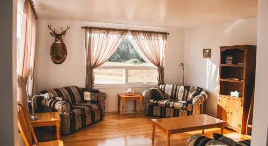 A cozy living room featuring comfortable sofas and decor inspired by the world of hunting.