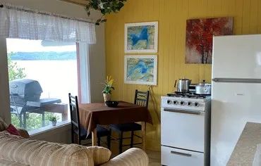 Kitchenette and dining area with a view of the lake inside the cabin.