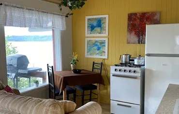 Kitchenette and dining area with a view of the lake inside the cabin.
