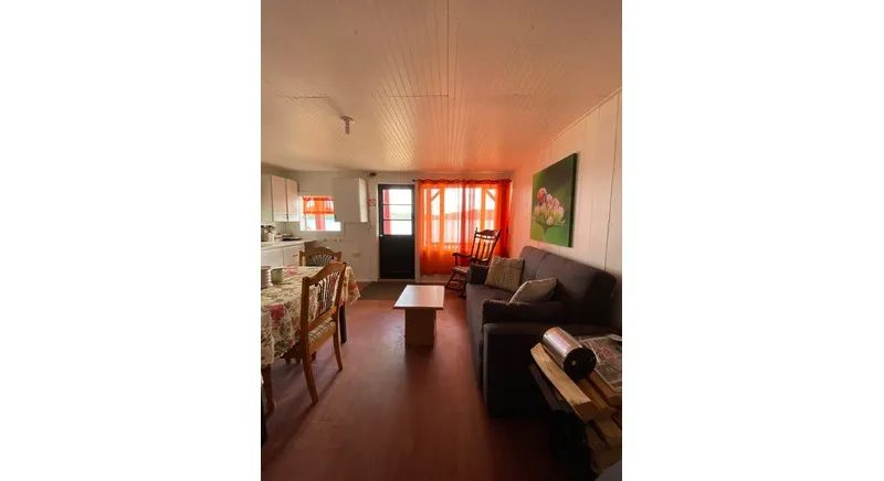 Overview of the cottage's main living area, including the living room and dining area.