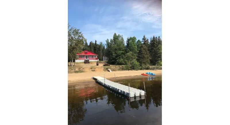 View of the cottage with its private dock and direct beach access.