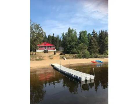 View of the cottage with its private dock and direct beach access.