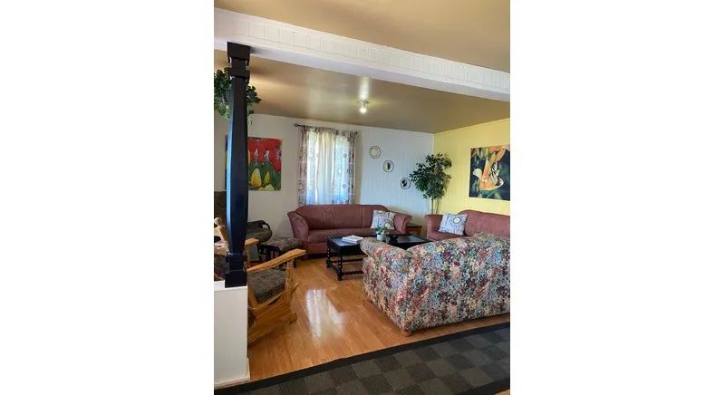 The living room of chalet 15 features comfortable sofas and hardwood flooring.
