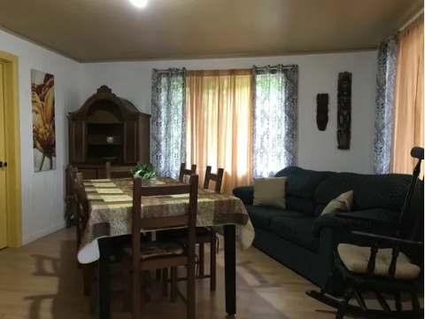 The dining area and living room of cottage 16 offer a cozy living space.