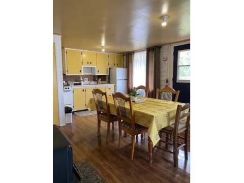 The cottage kitchen and dining area are equipped for preparing your meals.