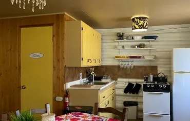 The cottage's equipped kitchen features a stove, a refrigerator, and workspace.