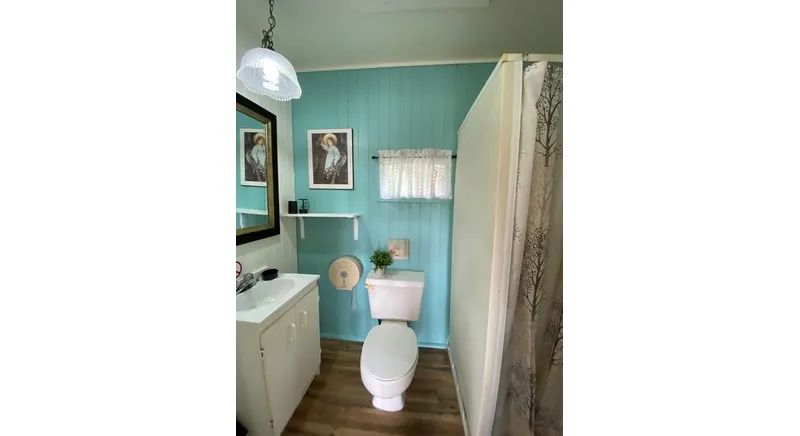 The chalet's functional bathroom includes a toilet, sink, and shower.