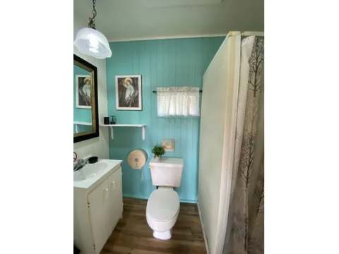 The chalet's functional bathroom includes a toilet, sink, and shower.