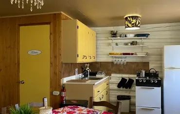 The cottage's equipped kitchen features a stove, a refrigerator, and workspace.
