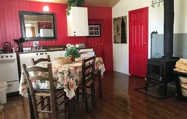 The chalet's kitchen and dining area feature a wood stove for your comfort.