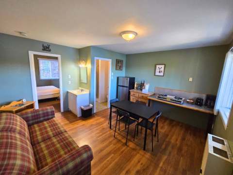 The Chevreuil studio features an open-concept area with a kitchenette, dining room, living area, and bedroom.