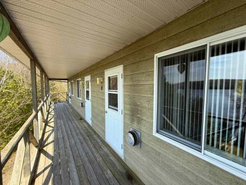 The outdoor balcony provides direct access to the private entrances of the studios.