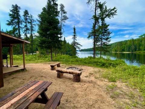 Enjoy the outdoor space with fire pit and lake view near the Coucoucache cottage.