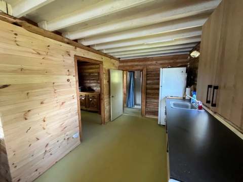 View of the functional kitchen and the entrances to the cottage bedrooms.