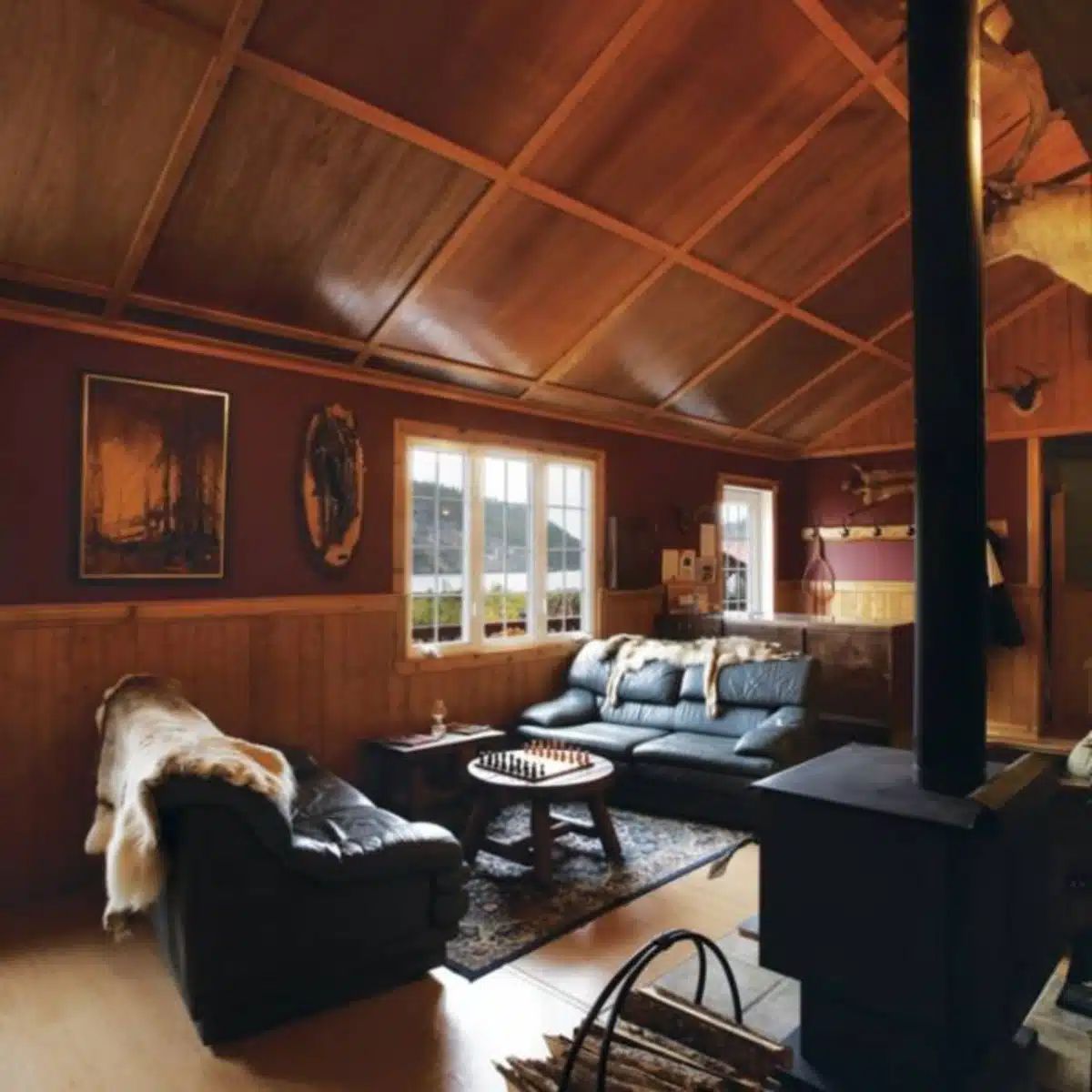The lodge living room features comfortable sofas and a wood stove for your relaxing moments.