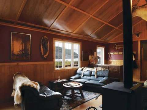 The lodge living room features comfortable sofas and a wood stove for your relaxing moments.