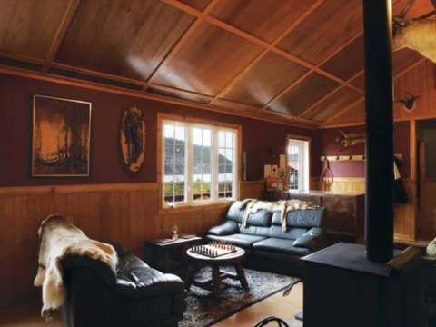 The inn's living room features leather sofas and a wood stove for a cozy atmosphere.
